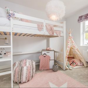 Young girl's bedroom with white loft bed, pink rug, pink throw, fluffy white light, beige tent and chic stool